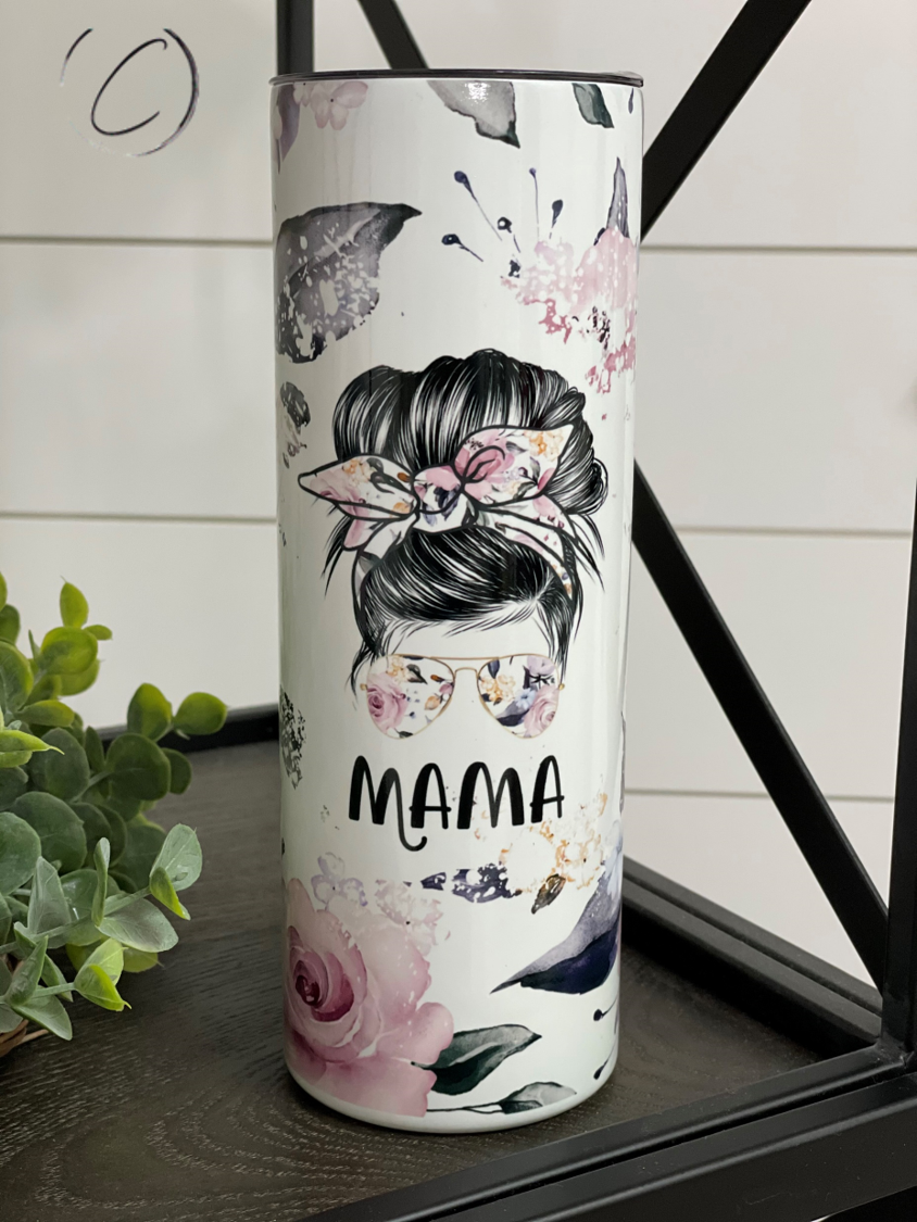 Floral Mama Messy Bun 20oz UV Blue Skinny Tumbler with a vibrant floral design and color-changing effect in sunlight.